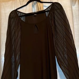 Slight puff mesh sleeve black top. Never worn but no tags